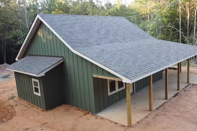 Small mountain style green one-story wood and board and batten exterior home photo in Jackson with a shingle roof and a gray roof