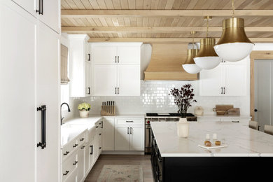 Mid-sized transitional light wood floor, beige floor and exposed beam eat-in kitchen photo in Philadelphia with shaker cabinets, white cabinets, marble countertops, an island and white countertops