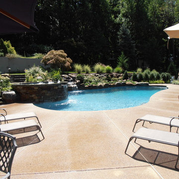 Upper Saucon Township custom built pool with raised spa, waterfall, & boulders