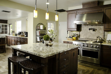 Large transitional u-shaped porcelain tile eat-in kitchen photo in Atlanta with a farmhouse sink, raised-panel cabinets, dark wood cabinets, quartzite countertops, beige backsplash, mosaic tile backsplash, stainless steel appliances and two islands