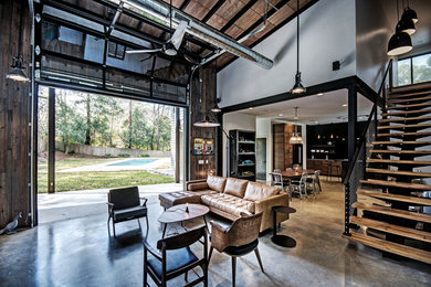 Living room - industrial open concept concrete floor and gray floor living room idea in Jackson with white walls