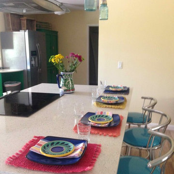 fun colored dinnerware on a recycled glass island countertop