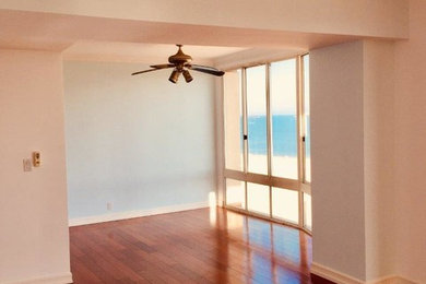 Example of a large transitional master medium tone wood floor and brown floor bedroom design in Los Angeles with beige walls and no fireplace