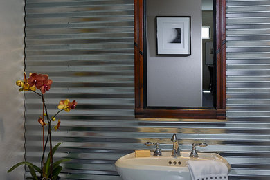 Powder room - small industrial porcelain tile powder room idea in Los Angeles with a pedestal sink and gray walls
