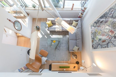 Mid-sized minimalist enclosed light wood floor family room photo in Los Angeles with white walls, no fireplace and a wall-mounted tv