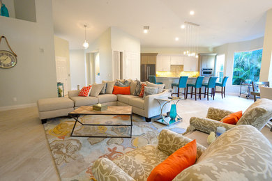 Large beach style open concept living room in Miami with beige walls, a built-in media wall and beige floor.