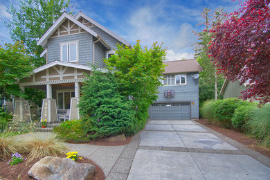 Example of a large arts and crafts blue two-story wood exterior home design in Seattle