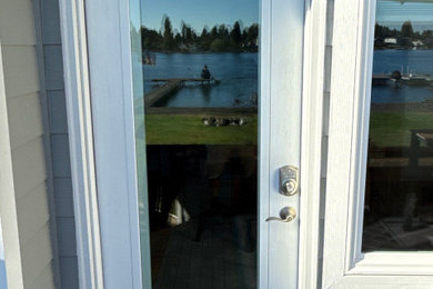 Example of a small trendy entryway design in Seattle with white walls and a white front door