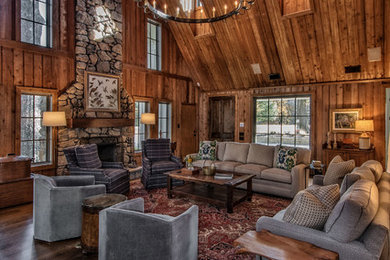 Mountain style formal and open concept dark wood floor and brown floor living room photo in Other with brown walls, a standard fireplace, a stone fireplace and no tv