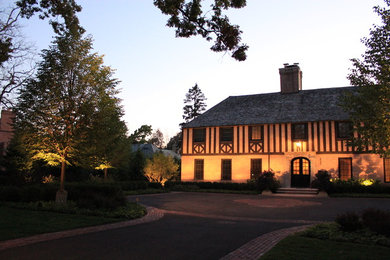 Example of a large classic beige two-story stucco house exterior design in Chicago with a hip roof and a shingle roof