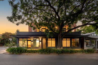 This is an example of a large modern two floor house exterior in Adelaide with mixed cladding and a flat roof.