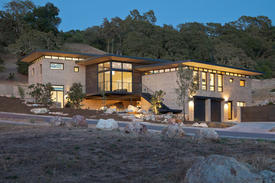 This is an example of a mid-sized contemporary two-storey adobe brown exterior in San Francisco with a flat roof.