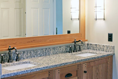 Mid-sized arts and crafts master vinyl floor, gray floor and double-sink bathroom photo in New York with recessed-panel cabinets, light wood cabinets, white walls, an undermount sink, granite countertops, gray countertops and a built-in vanity