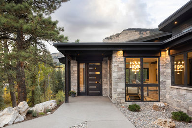 Large trendy gray two-story mixed siding house exterior photo in Denver with a shed roof, a metal roof and a black roof