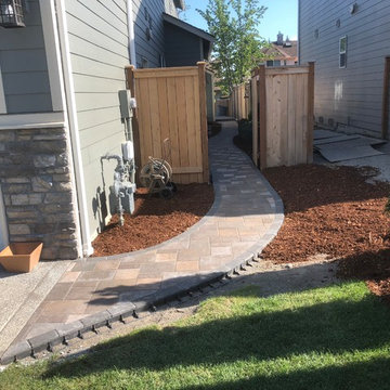 Raised holland patio and walkway with manor stone wall