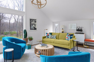 Inspiration for a contemporary open concept medium tone wood floor, brown floor and vaulted ceiling living room remodel in New York with white walls and no fireplace