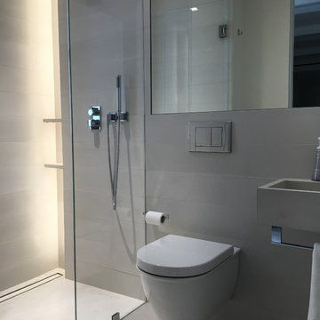 Concrete bathroom finishes - tiles, floor, sink.Private residence - Manhattan.