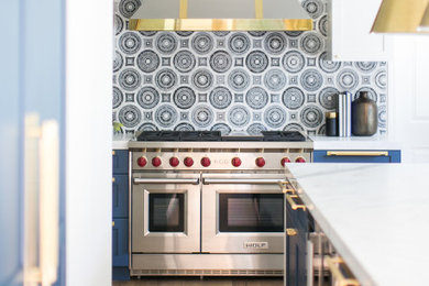 Inspiration for a large contemporary medium tone wood floor and brown floor eat-in kitchen remodel in Orange County with an undermount sink, shaker cabinets, blue cabinets, marble countertops, multicolored backsplash, marble backsplash, paneled appliances, an island and white countertops