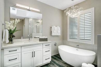 Inspiration for a mid-sized contemporary master beige tile and ceramic tile ceramic tile and double-sink bathroom remodel in Boise with shaker cabinets, white cabinets, a two-piece toilet, beige walls, an undermount sink, quartz countertops, a hinged shower door, white countertops and a built-in vanity