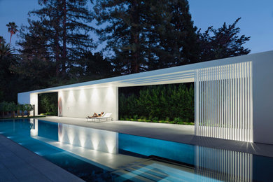 Example of a mid-sized minimalist white one-story glass exterior home design in San Francisco with a mixed material roof