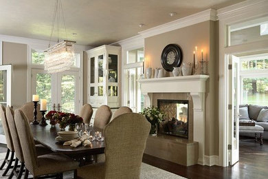 Mid-sized elegant dark wood floor kitchen/dining room combo photo in Louisville with beige walls, a two-sided fireplace and a tile fireplace