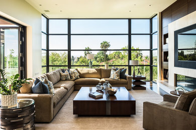 Example of a trendy dark wood floor family room design in San Francisco with beige walls and a ribbon fireplace