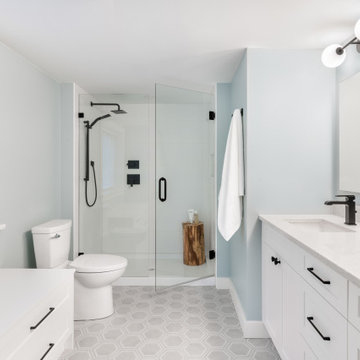 Light Blue Bathroom with Walk-In Shower and White Vanity
