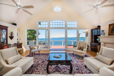 Living room - coastal medium tone wood floor living room idea in Vancouver with beige walls and a standard fireplace