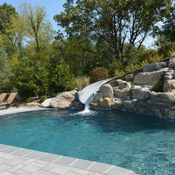 Custom Freeform style salt water in ground pool with Waterslide and Spa