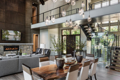 Mountain style medium tone wood floor, brown floor, vaulted ceiling and wood ceiling great room photo in Other with white walls