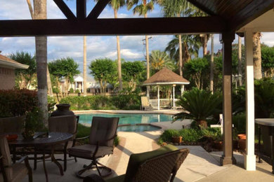 Patio - large transitional backyard concrete paver patio idea in Houston with a gazebo