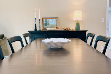 Example of a mid-sized transitional vinyl floor and brown floor great room design in Other with beige walls and no fireplace