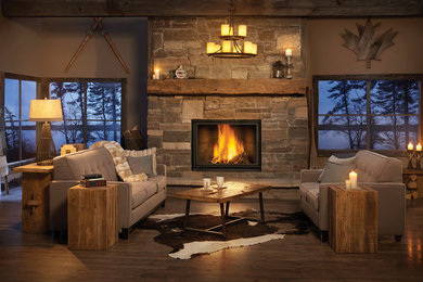 Living room - mid-sized rustic open concept dark wood floor and brown floor living room idea in Toronto with brown walls, a standard fireplace and a stone fireplace