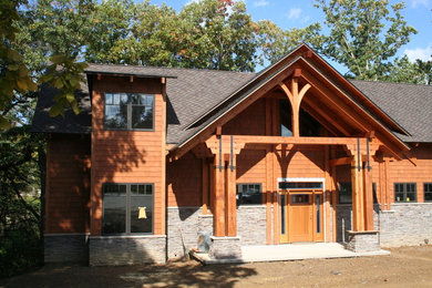 Example of an arts and crafts two-story mixed siding exterior home design in Other with a shingle roof