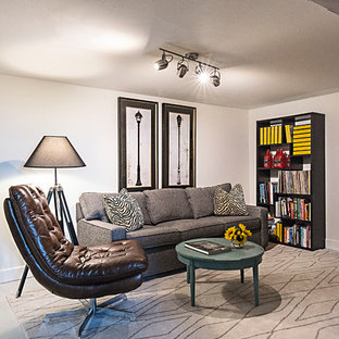 This is an example of a small bohemian fully buried basement in Nashville with white walls, painted wood flooring and white floors.