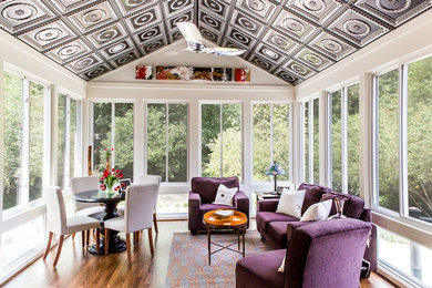 Design ideas for a mid-sized contemporary sunroom in Raleigh with medium hardwood floors and a standard ceiling.