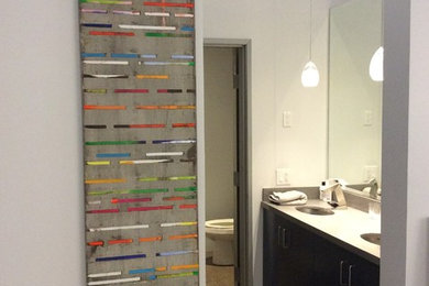 Example of a mid-sized trendy master concrete floor bathroom design in Los Angeles with flat-panel cabinets, black cabinets and white walls