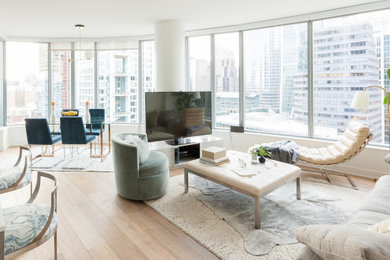 Inspiration for a contemporary light wood floor and beige floor living room remodel in San Francisco with white walls and a tv stand