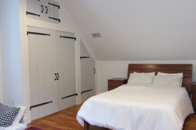 Bedroom - large country medium tone wood floor bedroom idea in Philadelphia with white walls