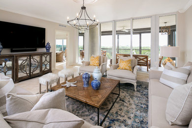 Large beach style open concept family room in Tampa with beige walls, travertine floors and a wall-mounted tv.