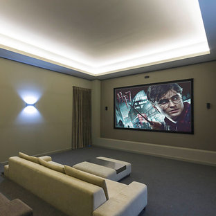 Example of a large trendy enclosed carpeted home theater design in Gold Coast - Tweed with brown walls and a projector screen