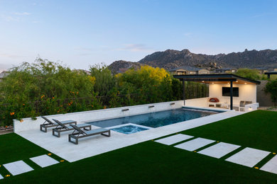 Hot tub - mid-sized contemporary backyard stone and rectangular hot tub idea in Phoenix