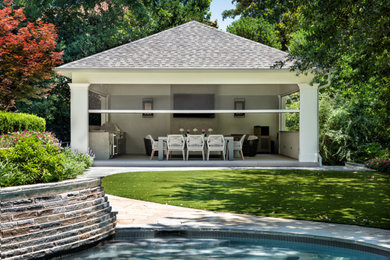 Outdoor kitchen deck - huge modern backyard ground level outdoor kitchen deck idea in Dallas with a pergola