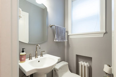 Small elegant marble floor powder room photo in St Louis with a one-piece toilet, gray walls and a pedestal sink
