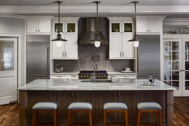 Design ideas for a large traditional single-wall open plan kitchen in Seattle with an undermount sink, recessed-panel cabinets, white cabinets, granite benchtops, grey splashback, subway tile splashback, stainless steel appliances, medium hardwood floors, with island, brown floor, grey benchtop and exposed beam.