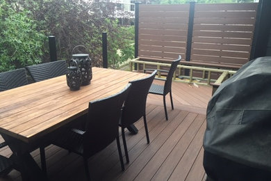 Deck - mid-sized contemporary backyard deck idea in Calgary