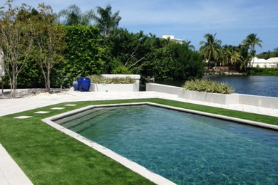 This is an example of a large traditional backyard concrete paver landscaping in Miami.