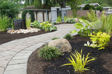 Design ideas for a mid-sized contemporary drought-tolerant and partial sun backyard brick water fountain landscape in Seattle.