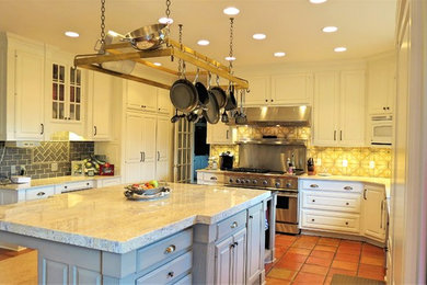 Example of a large classic l-shaped eat-in kitchen design in Other with a farmhouse sink, raised-panel cabinets, white cabinets, quartzite countertops, multicolored backsplash, porcelain backsplash, paneled appliances, an island and multicolored countertops