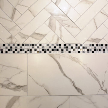 White and Gray MasterBath with Marble Look and Herringbone Tiled Shower
